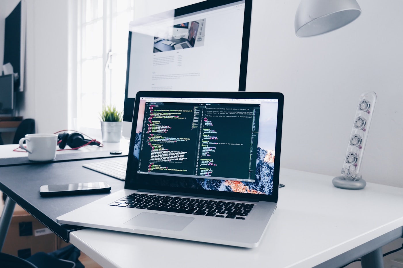 Website development on a laptop and desktop display